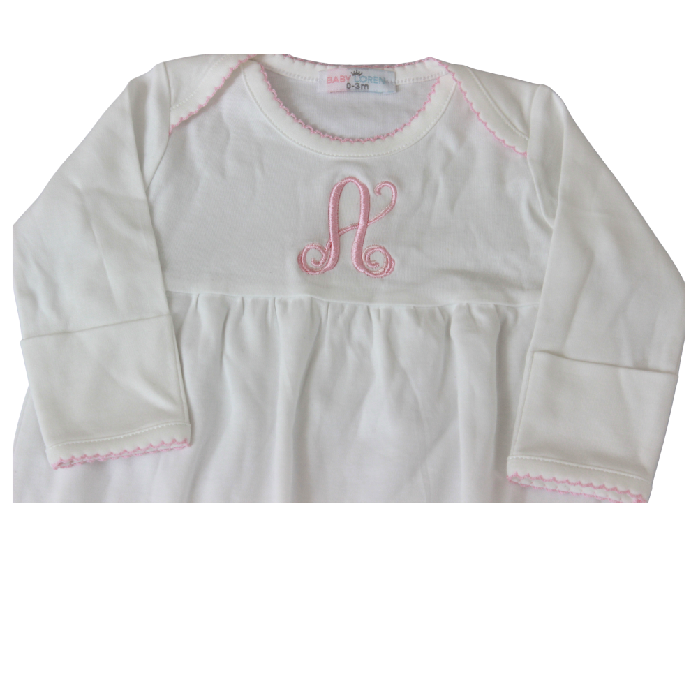 White baby gown with pink monogram and trim on a white background